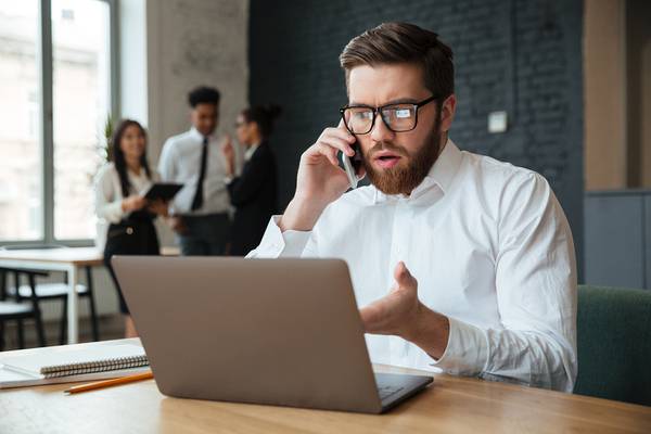 Man appearing confused while looking at his laptop screen