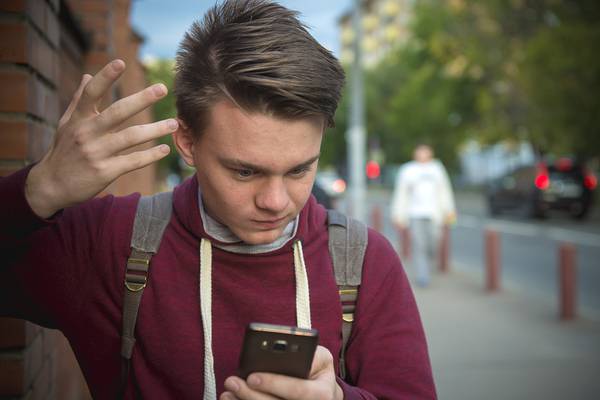 Confused boy on the phone.