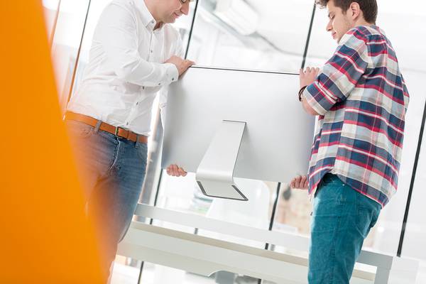 Men installing a computer in an office