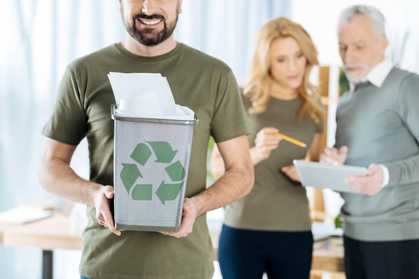 Office man with paper recycling bin