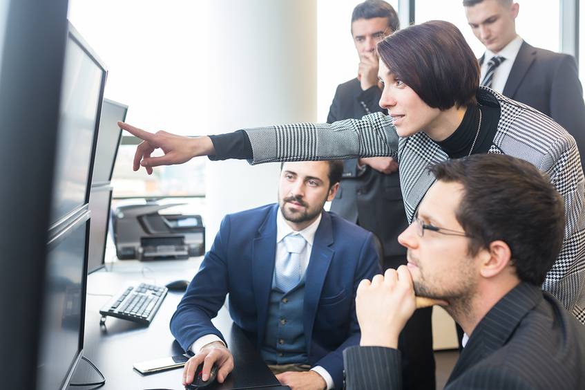 Group of people working together sharing data.